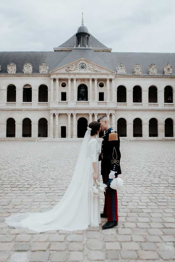 a kiss outside Cathedral of Saint Louis des Invalides