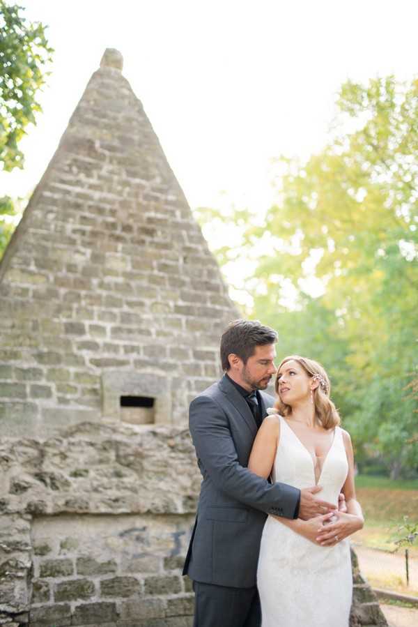 Bride and groom in front of egyptian pyramid in Parc Monceau Paris