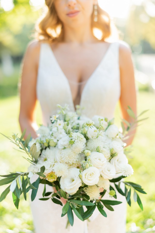 Bouquet held by bride in whites, creams and greens