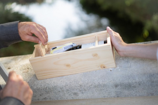 Red wine and keepsakes are sealed into wooden wine box