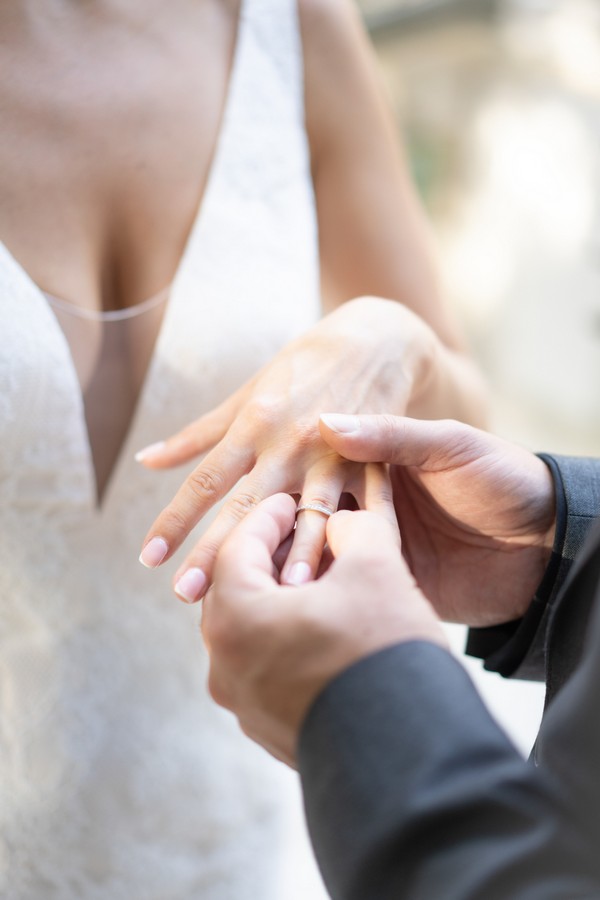 Groom places ring on brides finger
