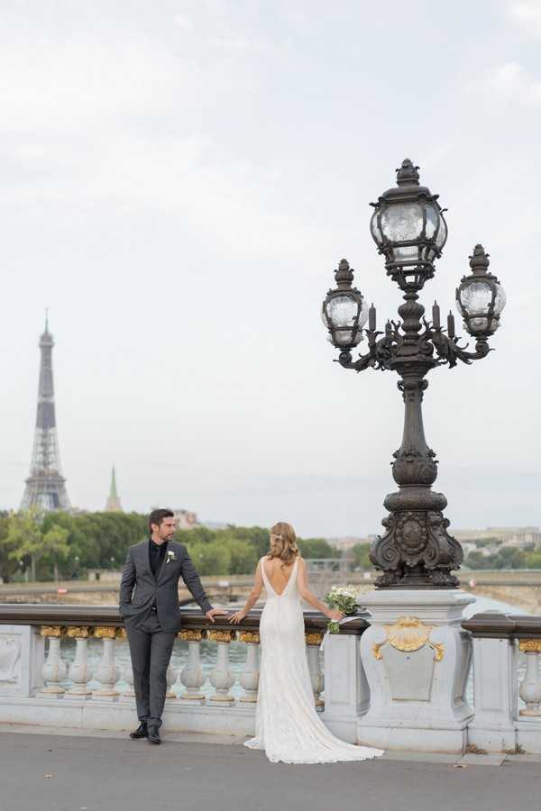 Bride and groom take in the view of the River Seine and the Eiffel Tower