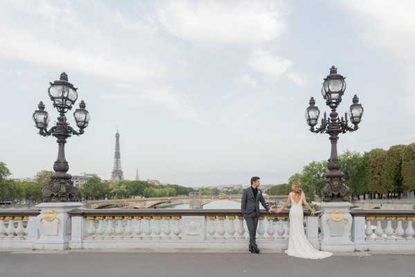 bride and groom look out across the Seine River