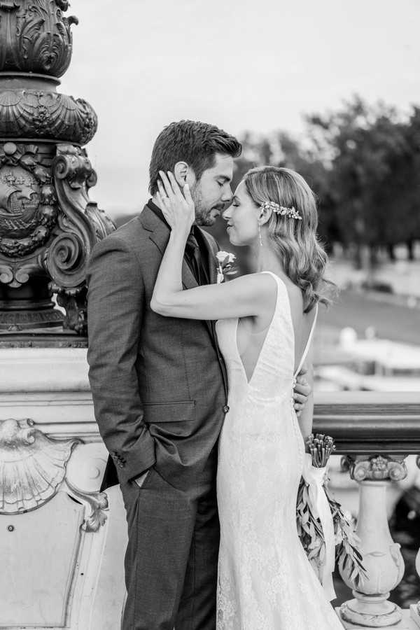 black and white image of bride holding grooms neck both with their eyes closed