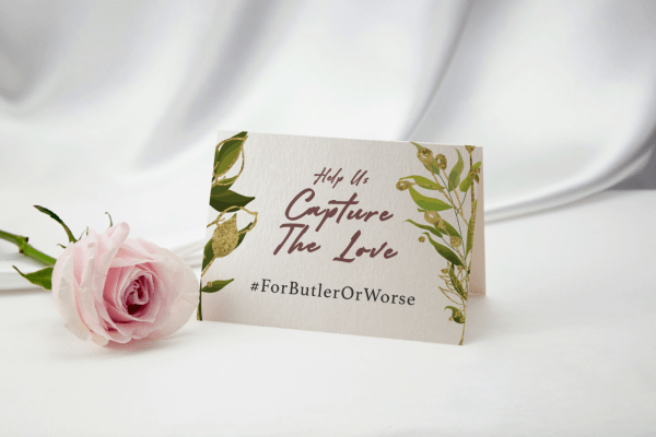 #ForButlerOrWorse on wedding table placeholder with pink rose