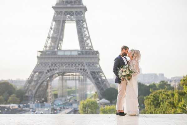 bride and groom in front of eiffel tower