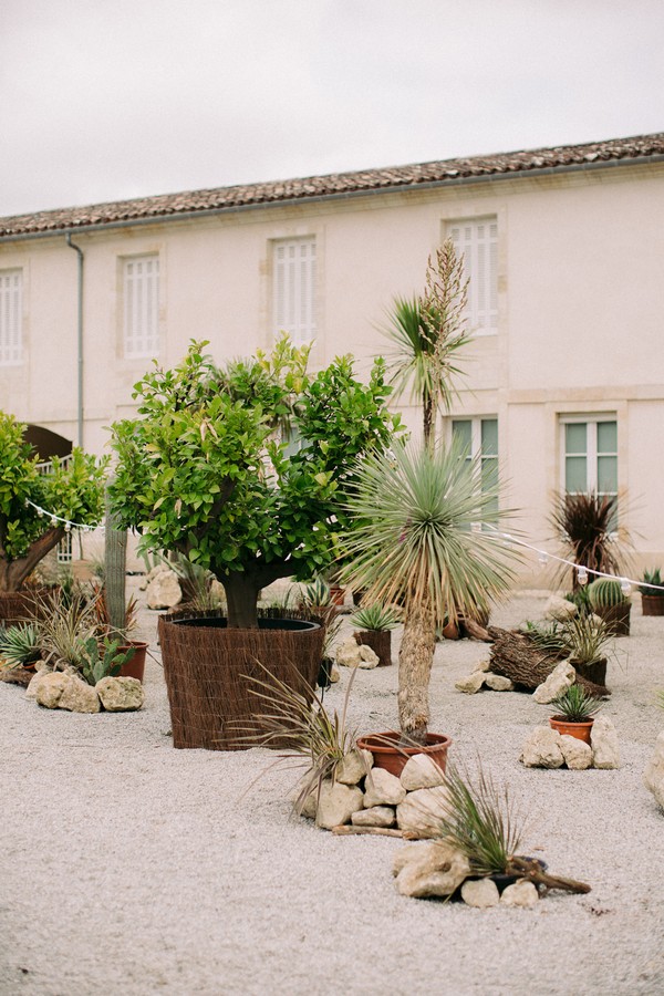 Chateau courtyard with pot plants and pebble path
