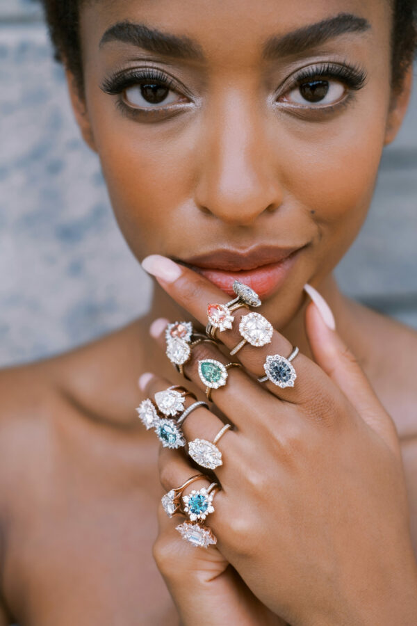 Lady with multiple Kristin Coffin rings on her fingers