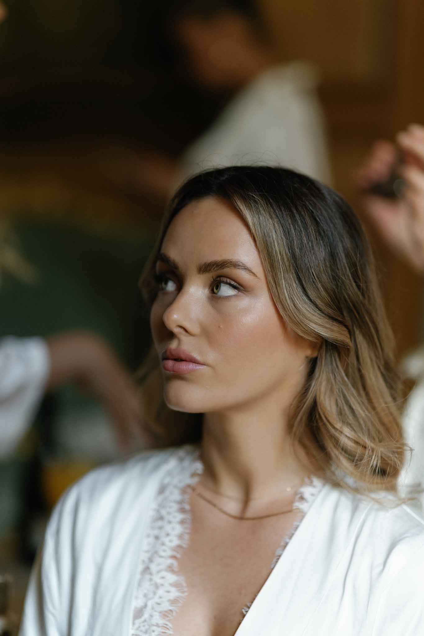 Bride in silk robe during getting ready preparations indoors