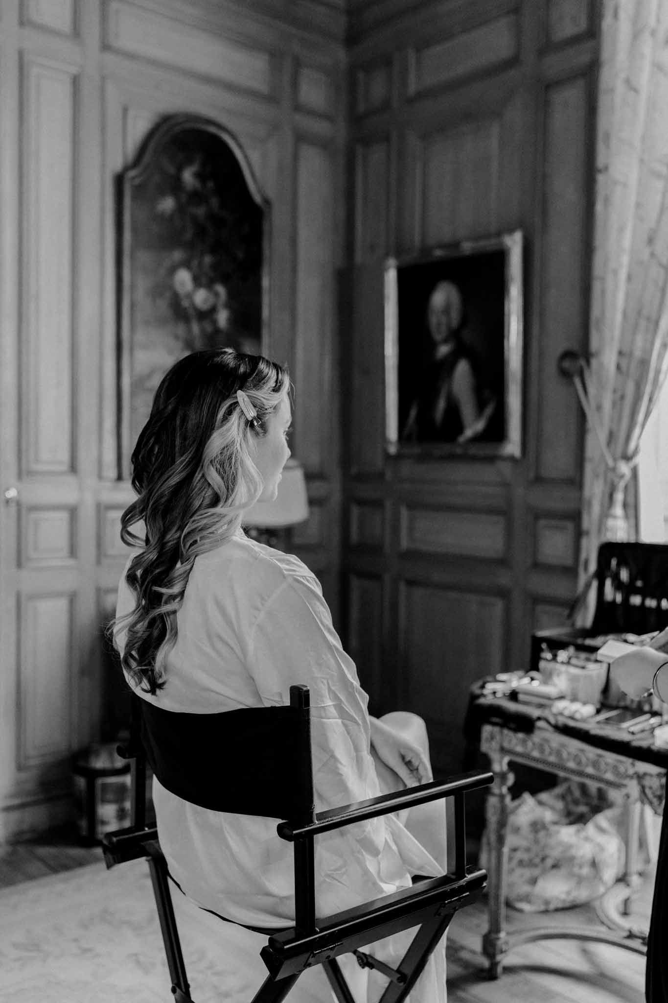 Bride getting ready in classical interior with paneled walls and period details