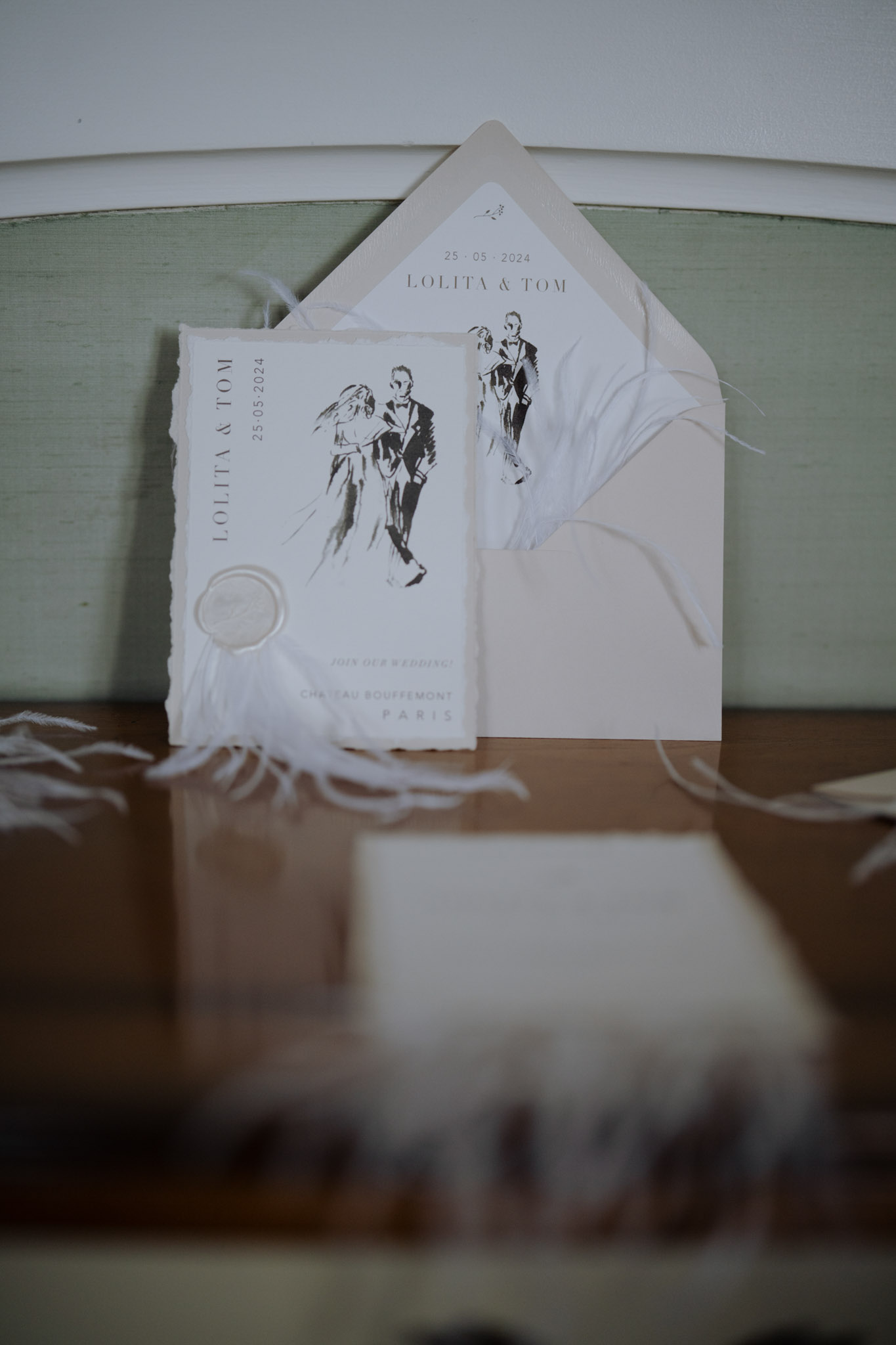 Deckled-edge invitation suite with dancing couple illustration and cream wax seal for Chateau Bouffemont