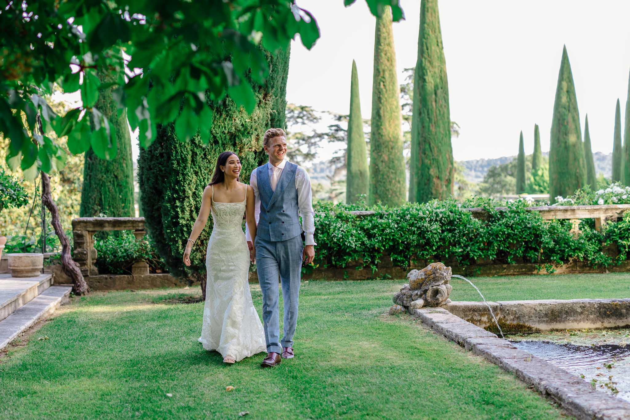 Outdoor reception table at ChÃ¢teau de Sannes with white and green floral centerpieces and place settings