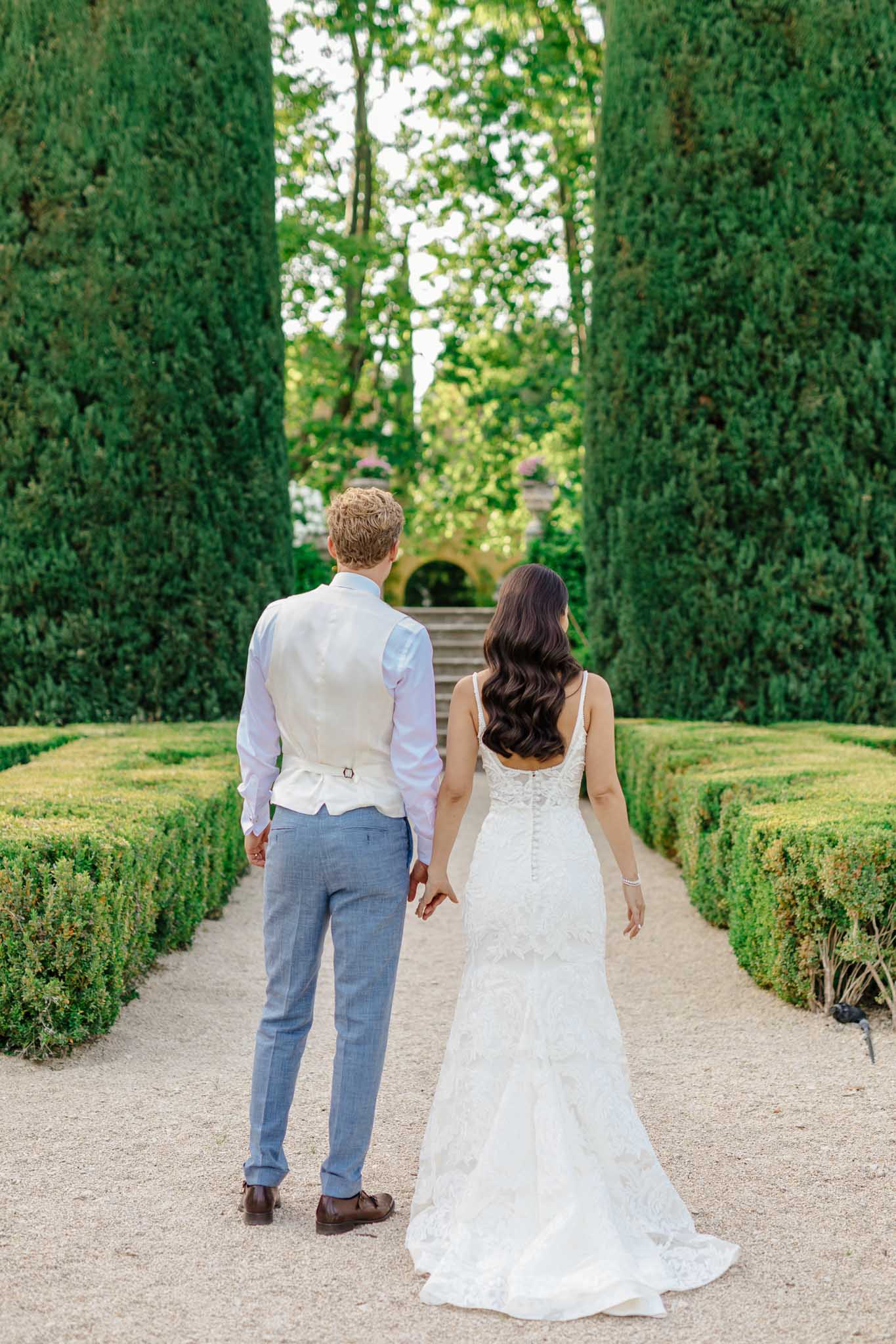 Bride and groom walking together at a French chateau
