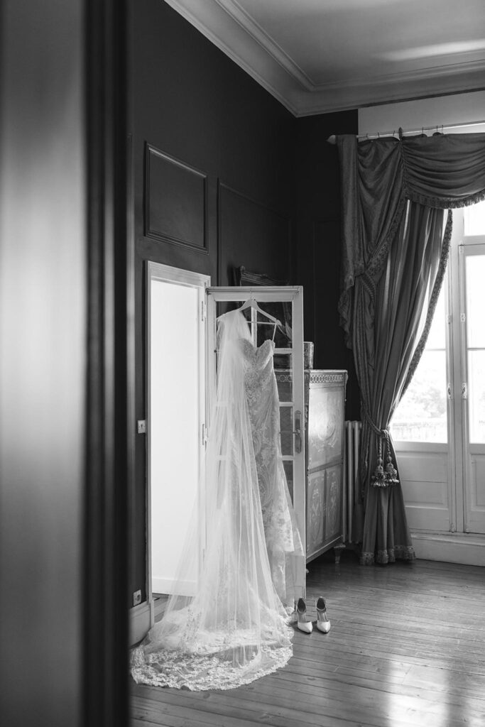 de la valouze a.bukowska wedding dress hanging in door