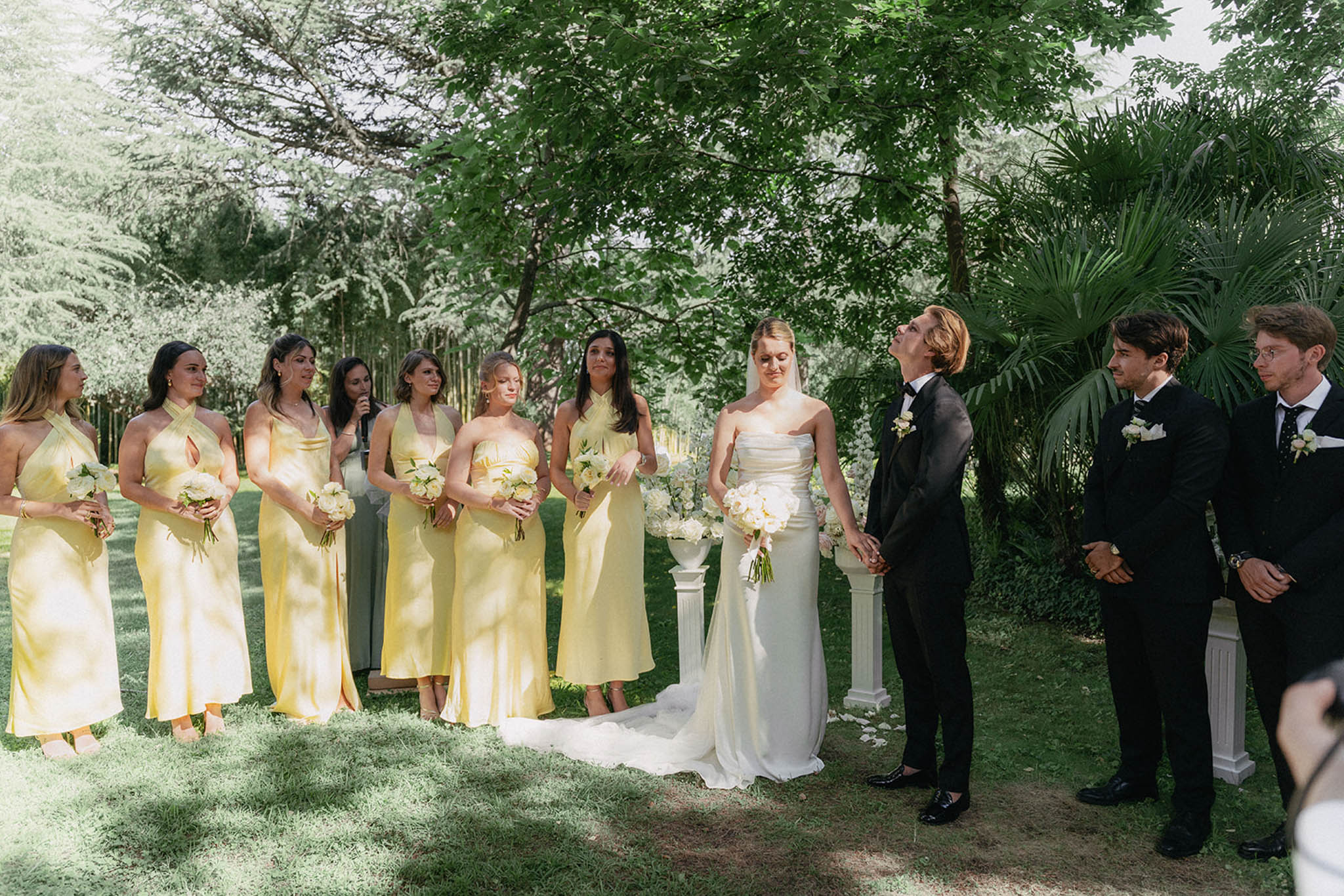 Bride and groom with their bridal party in a garden setting