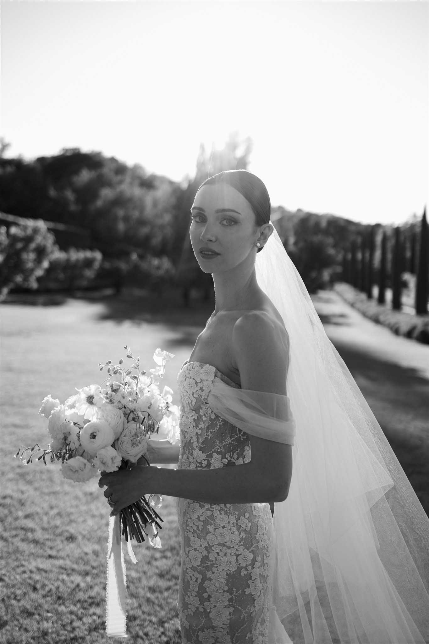 Bride in off-shoulder dress at Abbaye Saint-EusÃ¨be, black and white portrait photograph