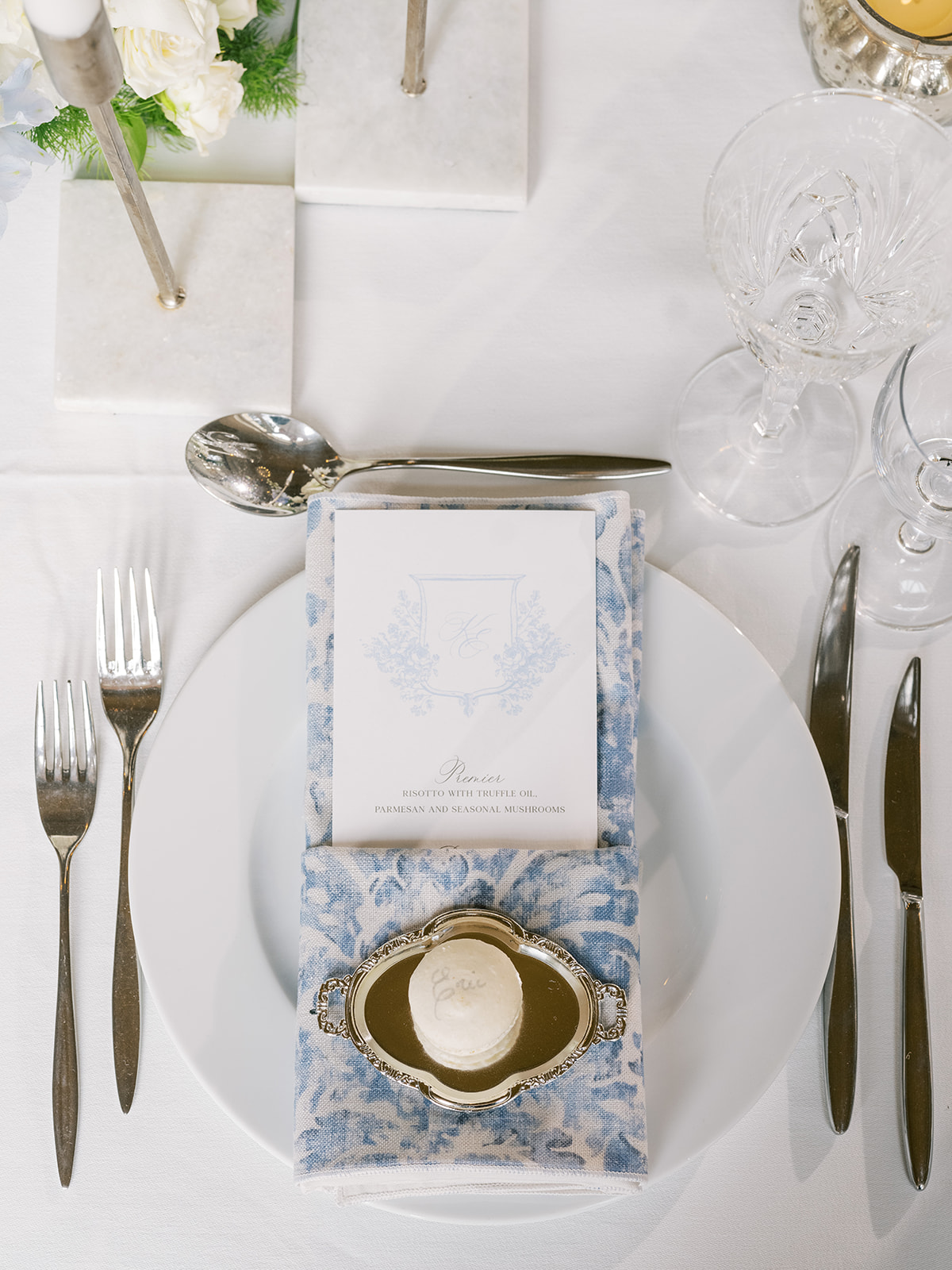 Formal reception table arrangement from above at Chateau Gassies with blue accent napkins and white floral centrepieces