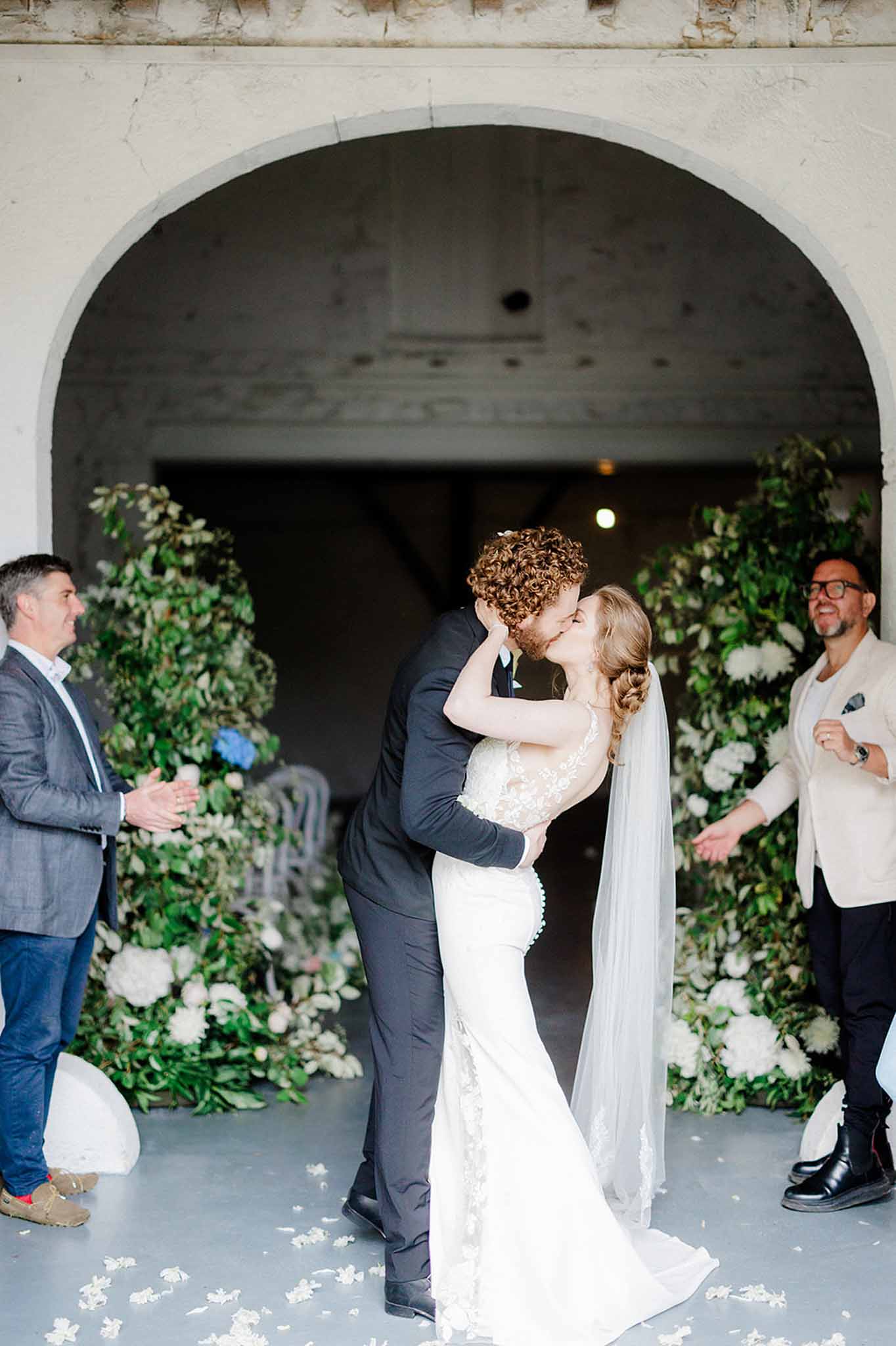 Bride and groom sharing a kiss in a garden setting
