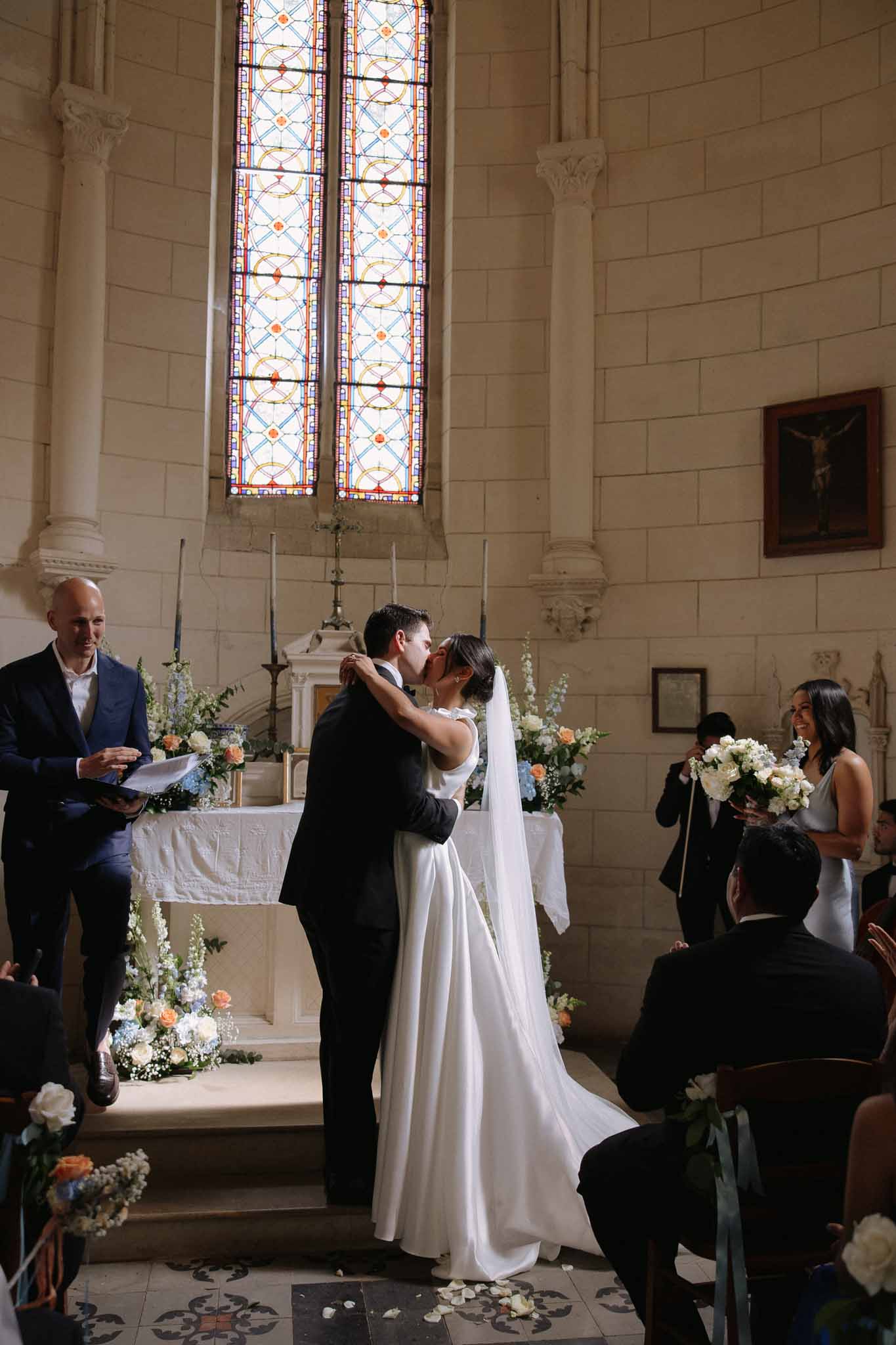 Bride and groom share their first kiss at the altar