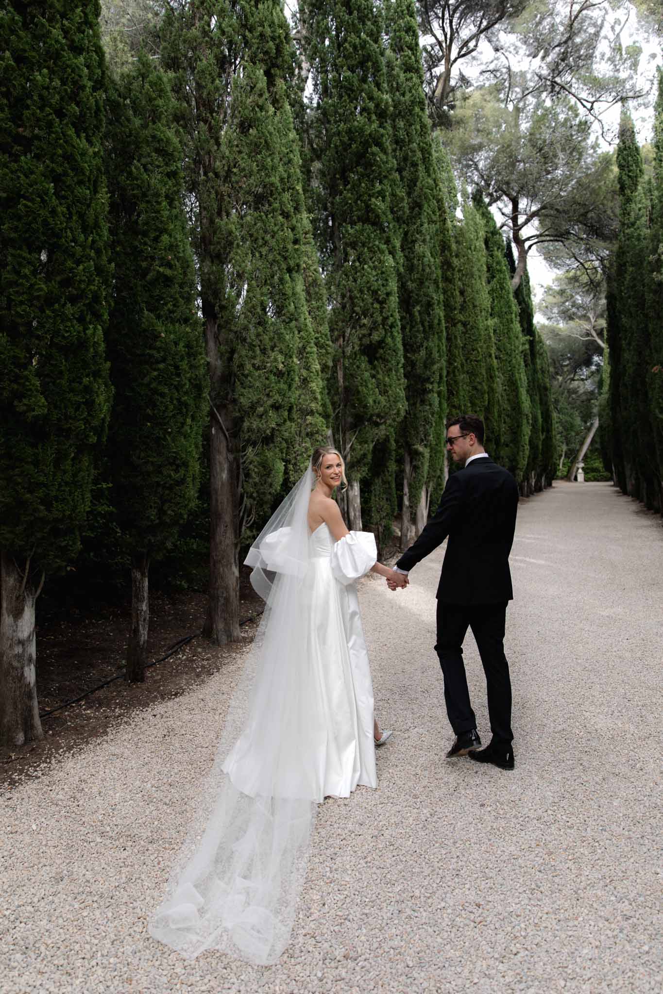 Bride and groom walking together at a French chateau