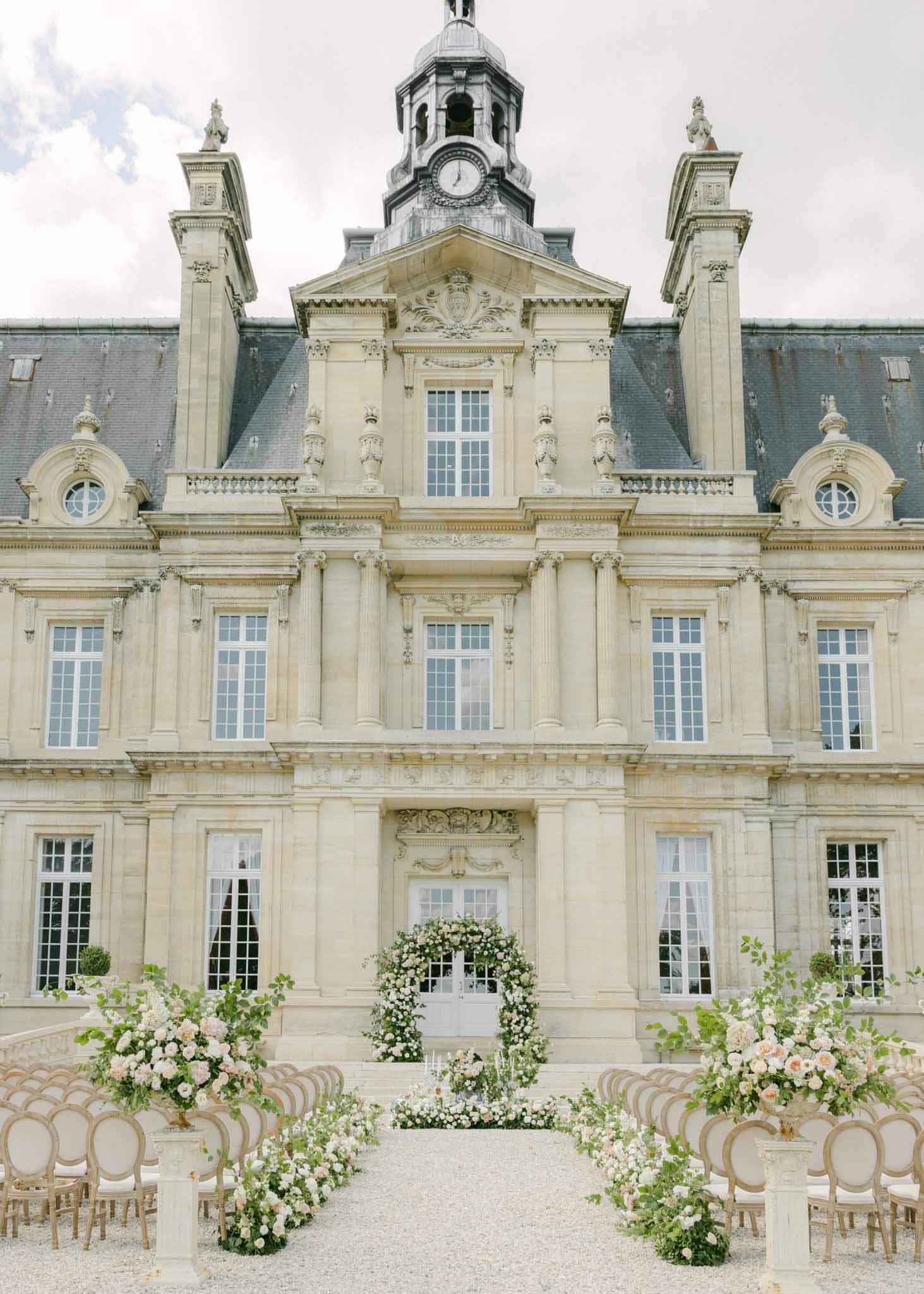 Old vintage front facade of ChÃ¢teau de Saint-Martin with outdoor ceremony setup on the grounds
