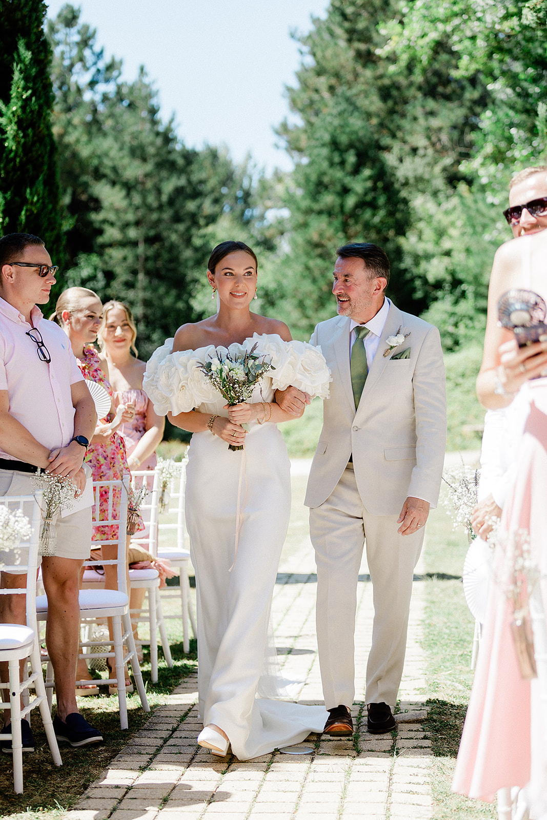 Bride and groom walking down outdoor aisle after ceremony at garden wedding venue