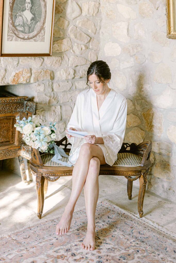 Chateau Cassis Olya bride sittint vintage gold chair reading letter