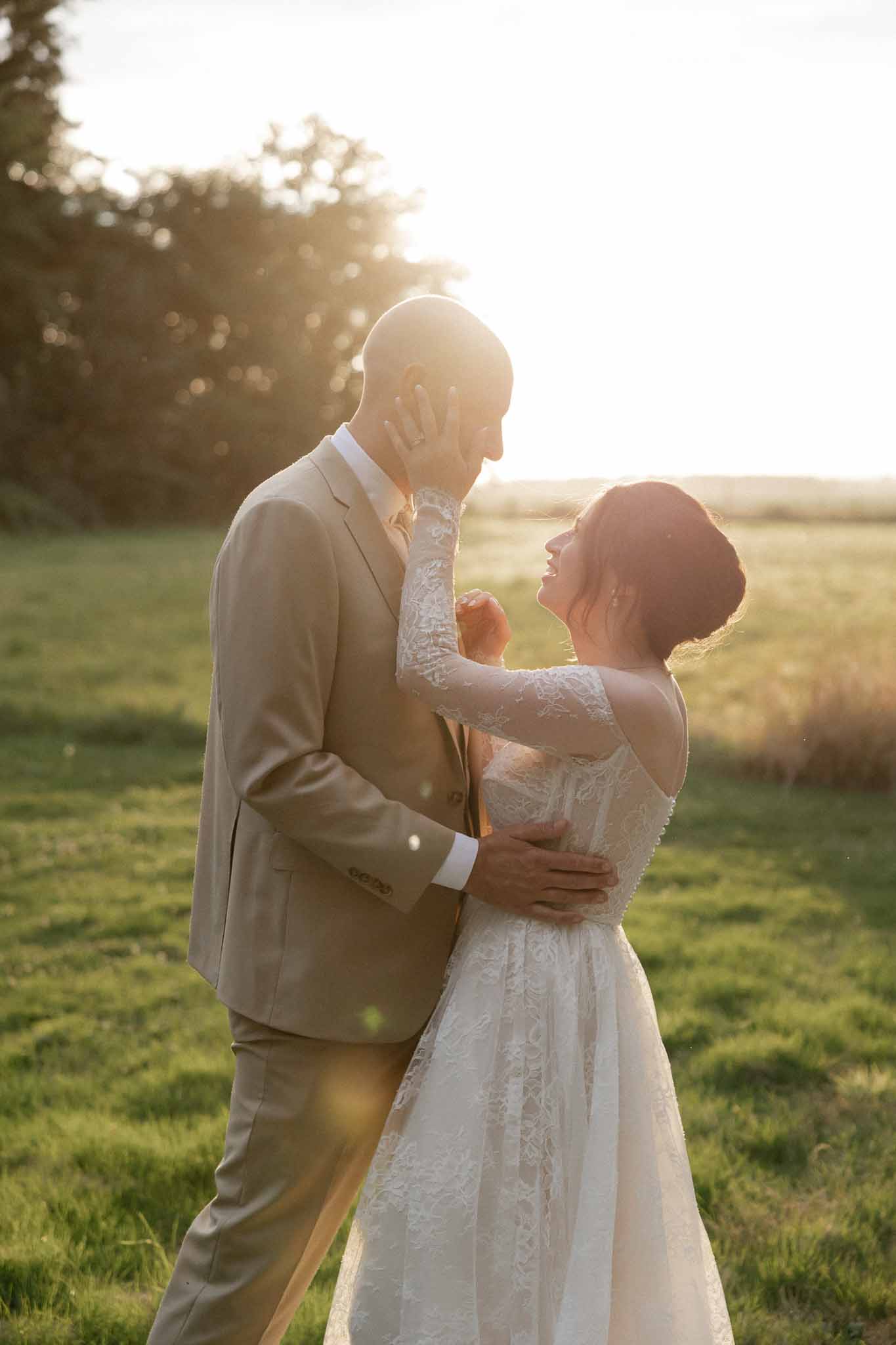 Bride and groom portrait during golden hour in rural field setting