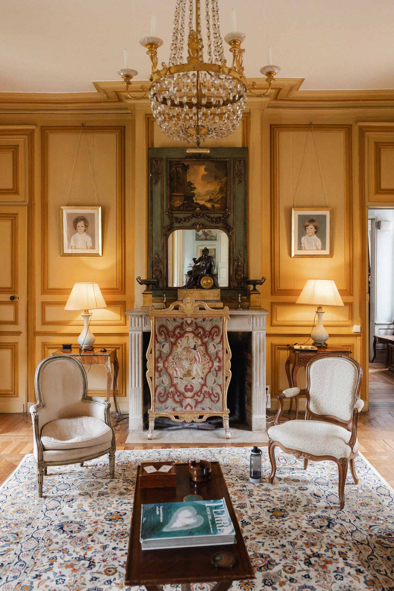 Classical French chÃƒÂ¢teau interior room with golden paneled walls and period furnishings for weddings