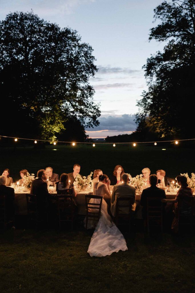 Chateau de Bouthonvillier Paco Aga reception table guests seated couple night string yellow lights