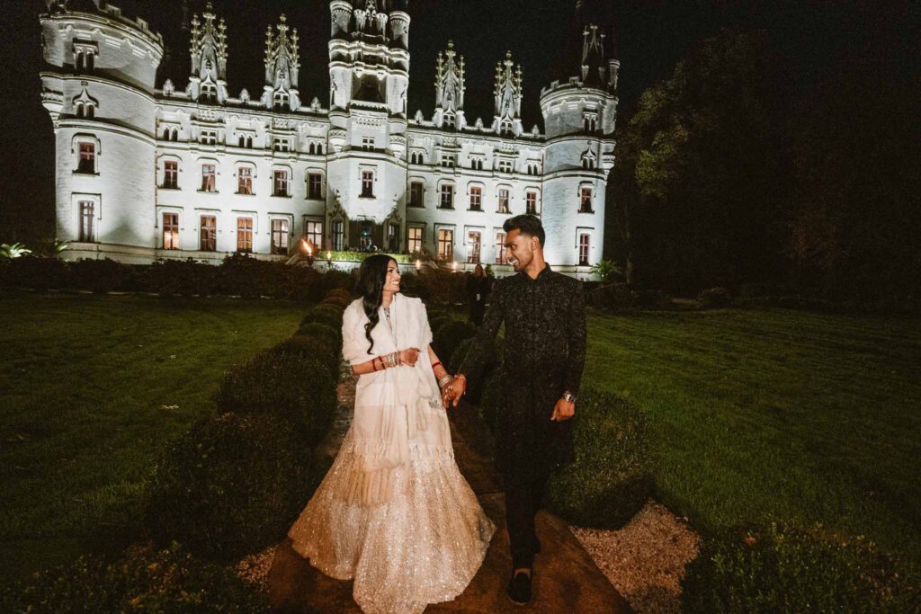 Chateau Challain F.Bandiera bride groom walking looking each other night venue background