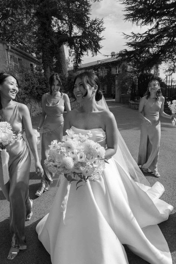 Domaine Mont Leuze CC Weddings bride bridesmaids formal shot outside vinatge gat walking black white photo candid