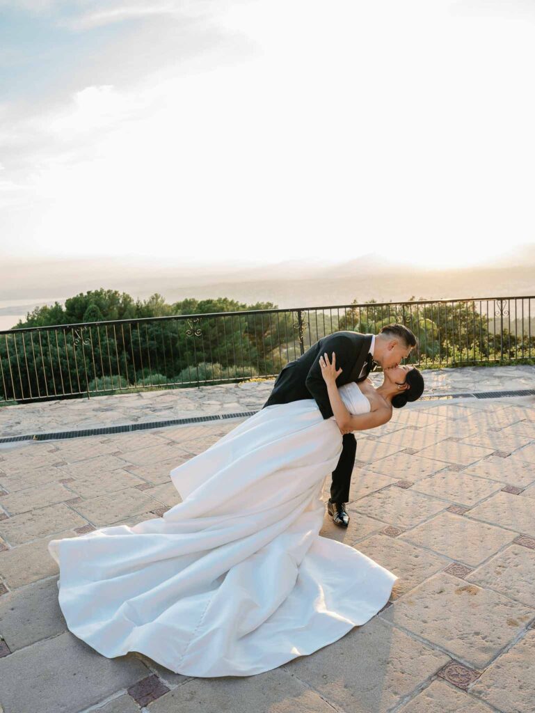 Domaine Mont Leuze CC Weddings bride groom dip kiss overlooking view