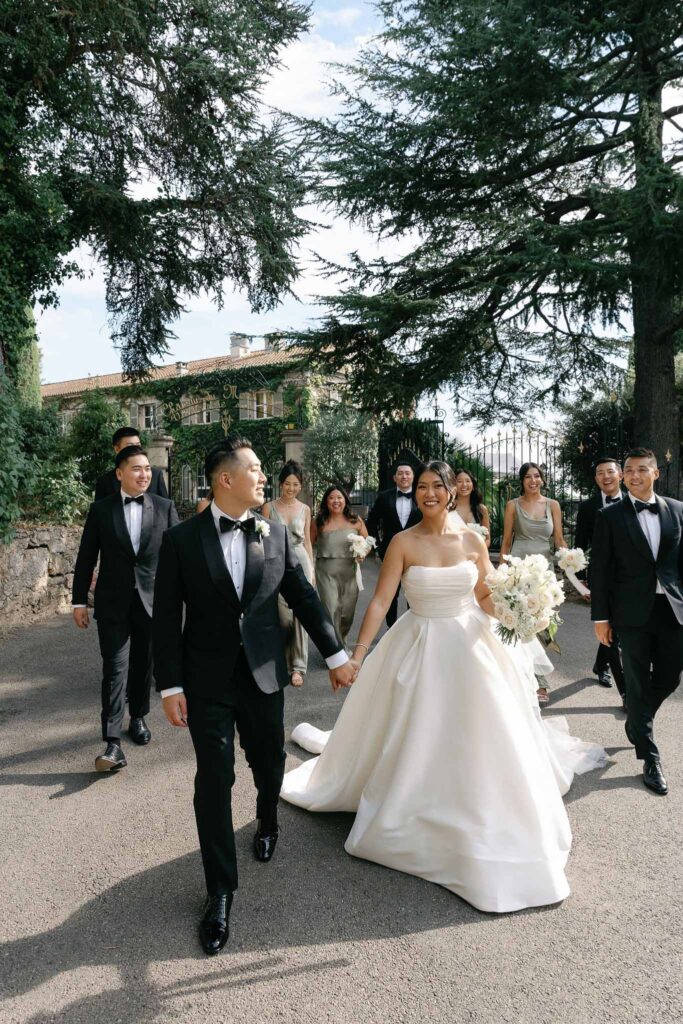 Domaine Mont Leuze CC Weddings bride groom holding hands entourage walking