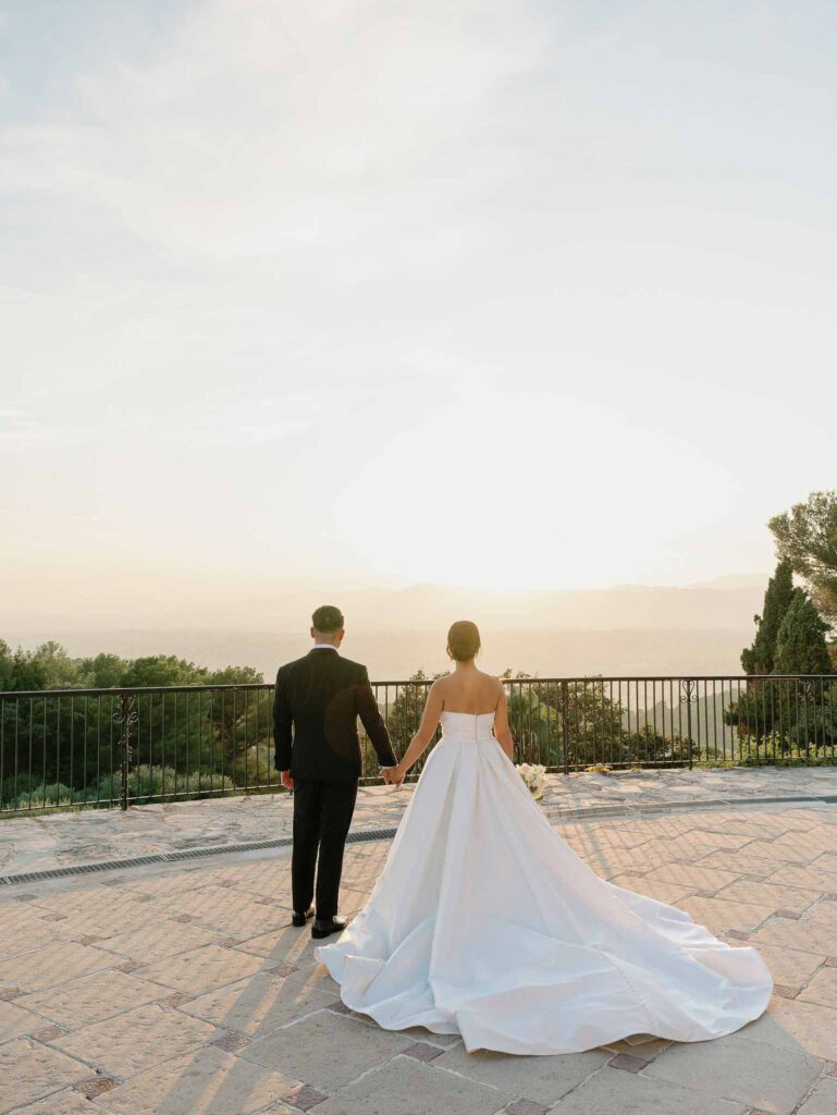 Domaine Mont Leuze CC Weddings bride groom holding hands overlooking view sunset back shot
