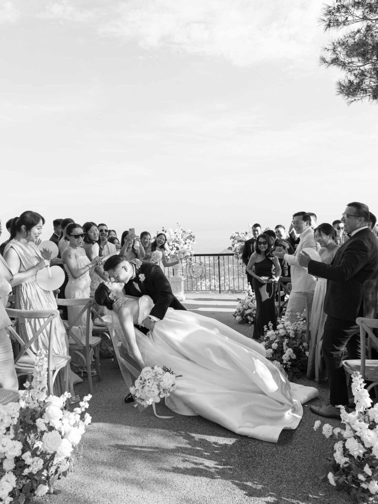 Domaine Mont Leuze CC Weddings bride groom kiss dip center aisle black white photo