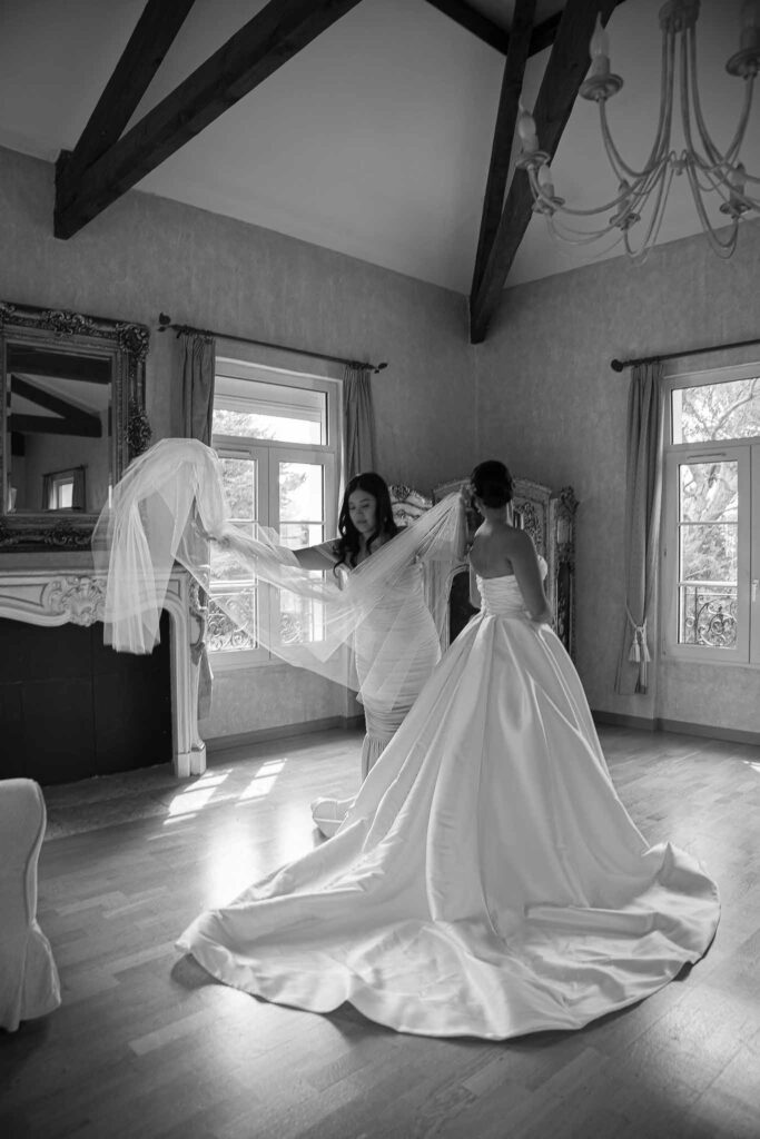 Domaine Mont Leuze CC Weddings bride maid of honor fixing veil black white photo