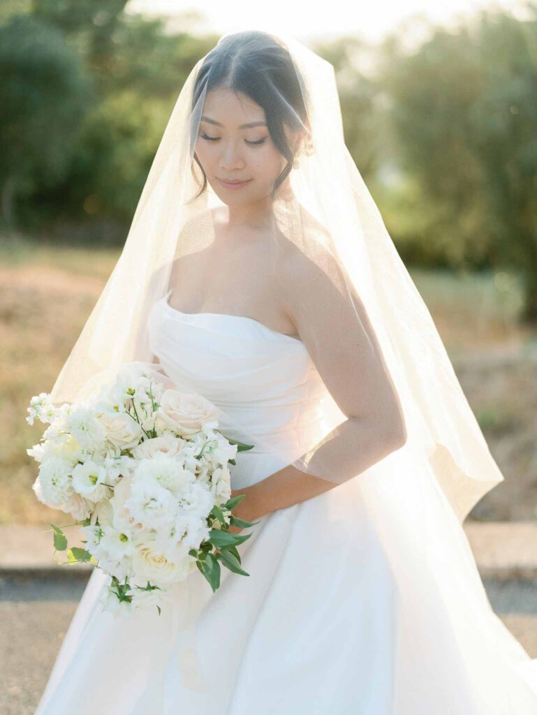 Domaine Mont Leuze CC Weddings bride strapless dress long trail veil face holding bouquet