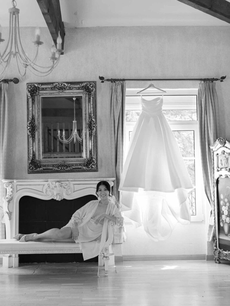 Domaine Mont Leuze CC Weddings bride vintage chair beside dress hanging black white photo