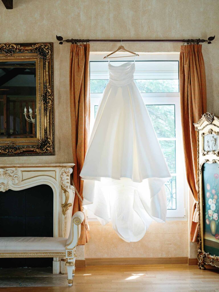 Domaine Mont Leuze CC Weddings detail shot strapless dress hanging window rust curtain