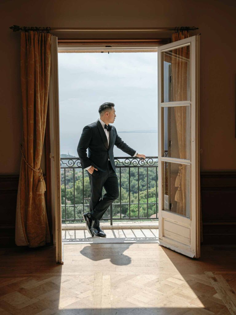 Domaine Mont Leuze CC Weddings groom standing vinatage balcony overlooking view