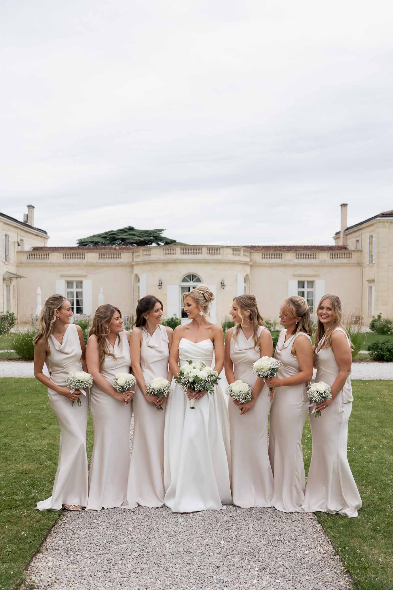 Bride and bridesmaids formal group portrait at classical estate mansion
