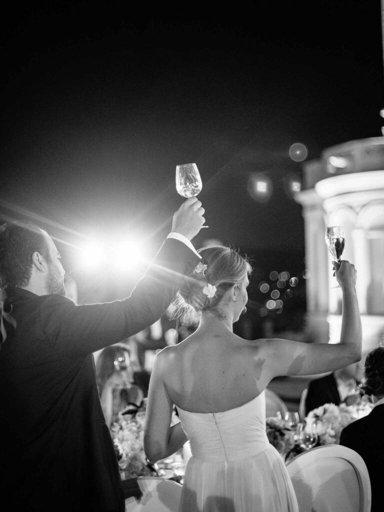Villa Ehprussi Tatyana bride groom champagne glasses toast guests reception black white photo