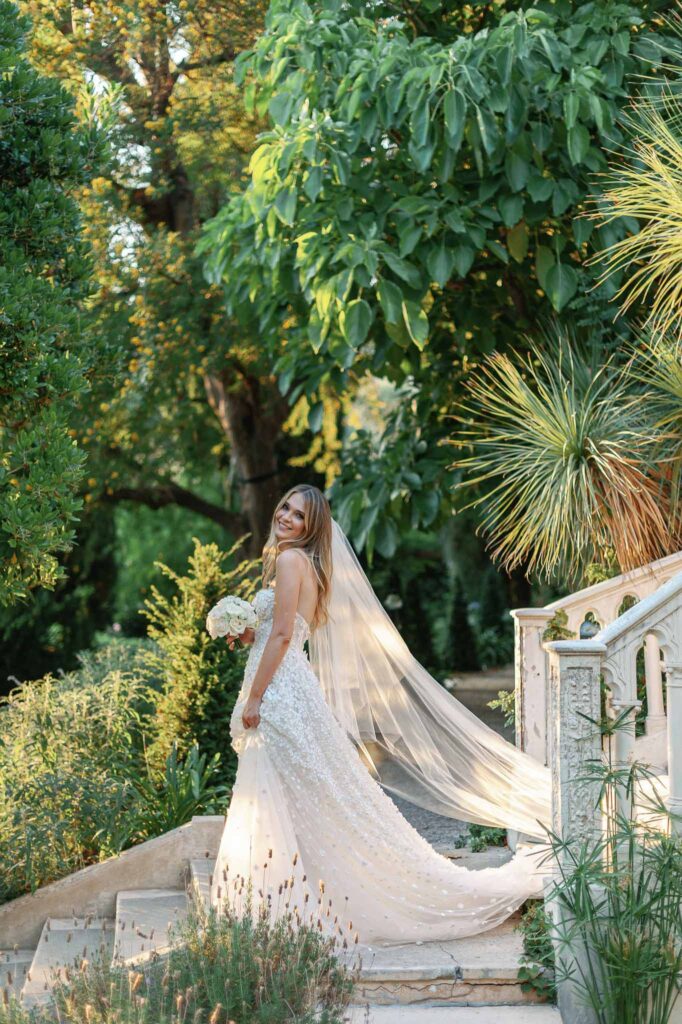 Villa Ehprussi Tatyana bride lace floral strapless dress holding bouquet stairs garden sunset