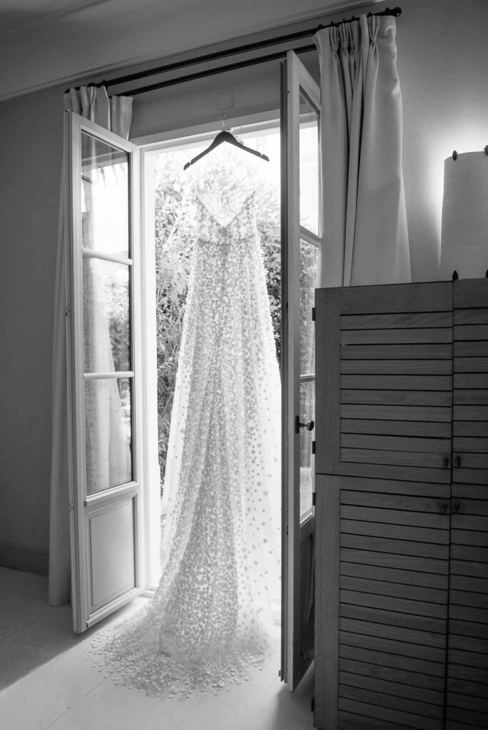 Villa Ehprussi Tatyana detail shot bride strapless floral dress hanging by window black white photo