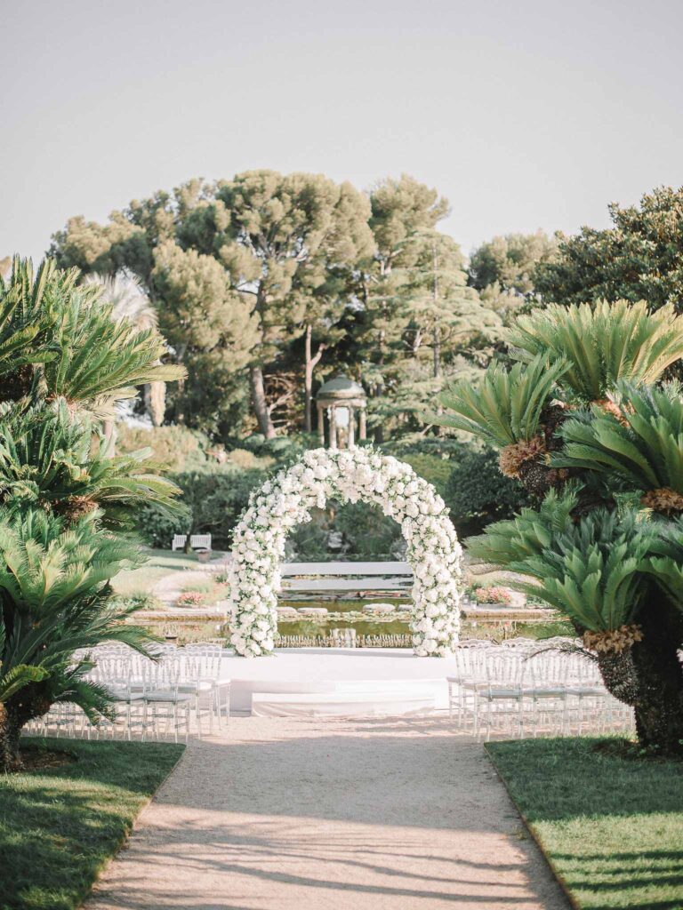 Villa Ehprussi Tatyana detail shot ceremony area white flower arc trees garden