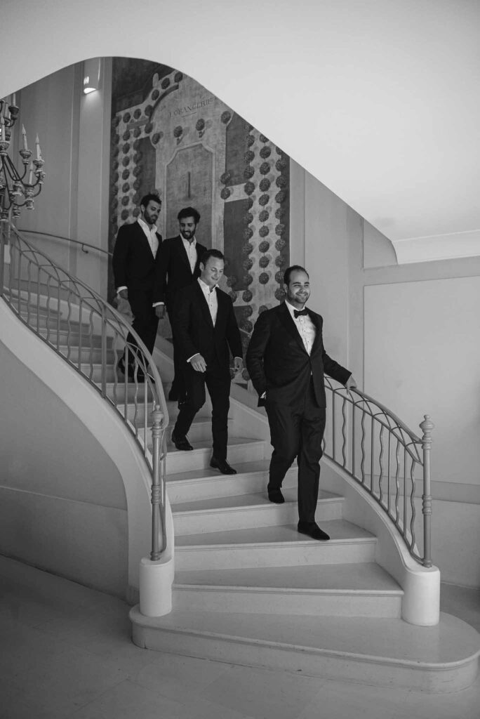 Villa Ehprussi Tatyana groom groomsmen walking down stairs black white photo