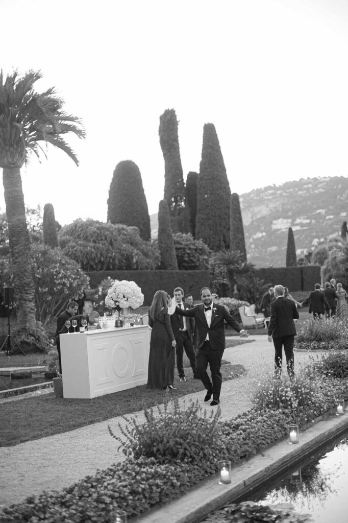 Villa Ehprussi Tatyana groom walking fountain garden venue black white photo