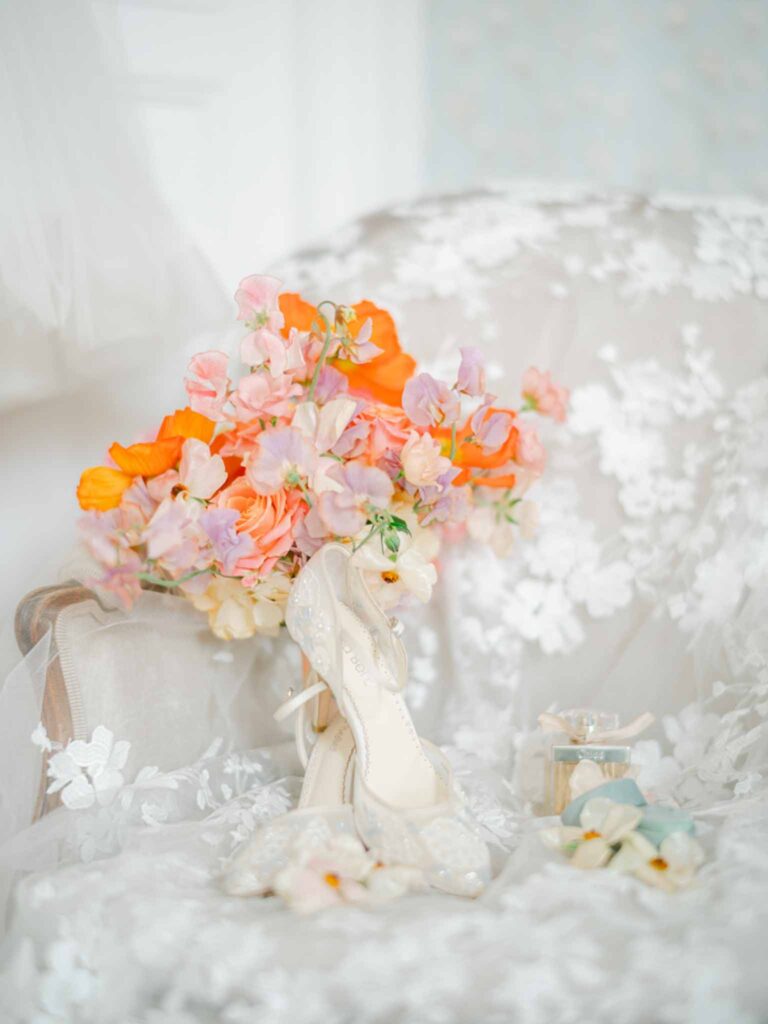 Château Belle Epoque Adeline Murzeau flatlay detail shot bride pointed white shoes colorful bouquet