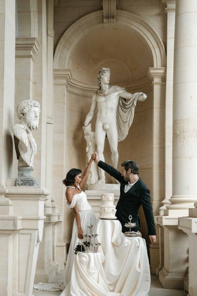 Chateau de Ferrieres Avecamour bride groom holding hands cake champagne glass tower oysters big vintage statue background
